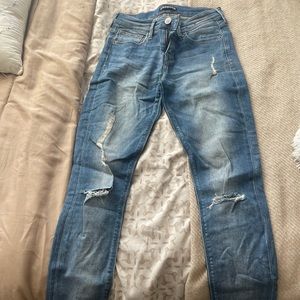 Express medium wash distressed skinny jeans.